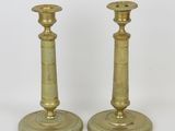 pair of antique brass candlesticks on a white background