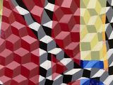 an abstract painting of a red, yellow, blue, and black geometric pattern