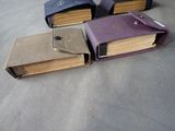 several books are lined up in a row on a table