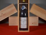 a bottle of wine in a wooden box on a table