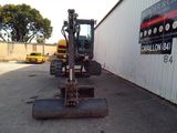 an image of a construction vehicle parked in front of a building