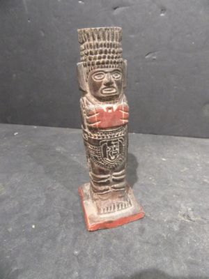 a wooden statue that is sitting on a table
