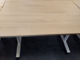a close up of a wooden table with a white base