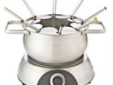 a fondgril pot with a bunch of forks in it