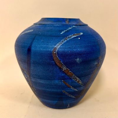 a blue vase that is sitting on a table