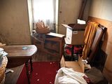 a room with a red carpet, a table, a chair, and a window