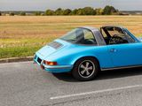 a blue car that is parked on the side of the road