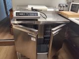 a stainless steel oven with a door open on a kitchen counter