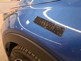 a close up of a blue car with a sticker on it
