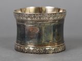 an antique silver plated napkin ring with a design on it