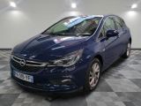 the blue opel is parked on a checkered floor in a garage