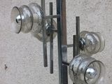 a metal pole with glass vases on top of it