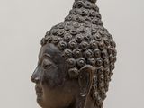 a close up of a statue of a head on a table