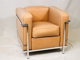 fauteuil en cuir beige avec des pieds chromés sur fond blanc