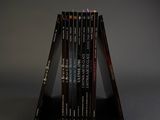 several books stacked on top of each other on a black surface