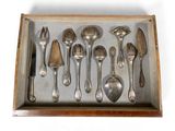 silverware in a wooden box on a white surface with a knife and spoon