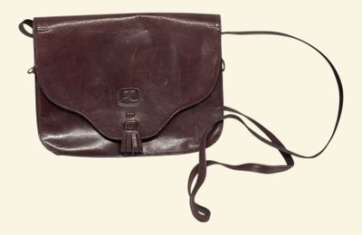 brown leather cross body bag with shoulder strap on white background