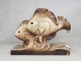 a figurine of a fish and a fish on a wave