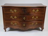 a wooden chest of drawers with gold handles on it