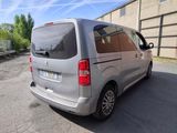 a silver van that is parked in a parking lot