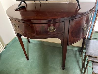 a small wooden table with a tv on top of it