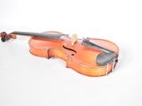 a violin that is sitting on a white surface