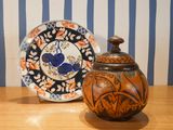 a vase and a plate sitting on a table