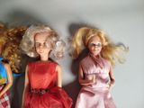 three dolls that are sitting next to each other on a table