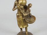 bronze figurine of a woman holding a basket and a child