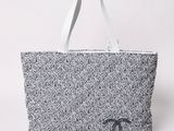 a black and white bag with a chanel logo on it