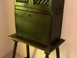 an old wooden cabinet with a door on top of it