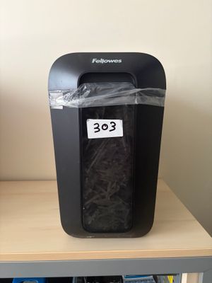 a paper shredder sitting on top of a shelf