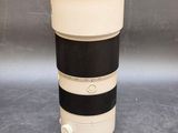 a camera lens sitting on a table next to a cup of coffee