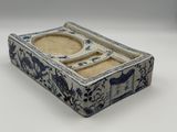 a small blue and white box with a tray on top of it
