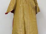 an image of a yellow and red dress on a mannequin stand