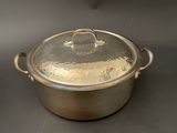 an image of a large metal pot with a lid on a table