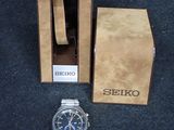 a watch sitting next to a box on the floor