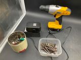 a drill, screws, and a bucket of screws on the counter