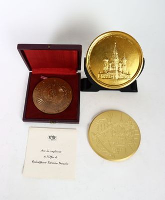 an image of a gold medal in a red box with a card