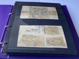a purple binder with drawings on it on a table