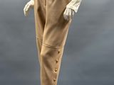 an image of a mannequin wearing beige pants and a white shirt