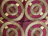 a close up of a red and brown tie with a design on it