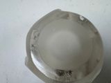 a close up of a plastic object on a white surface