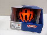an orange helmet in a blue box on a white table