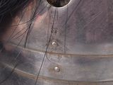 a close up of a metal helmet with a hole in it