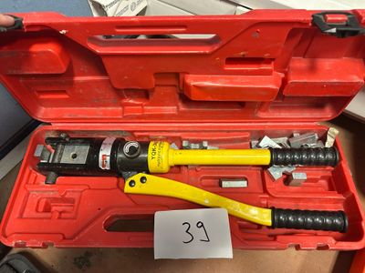 someone is holding a tool in a red case with a price tag