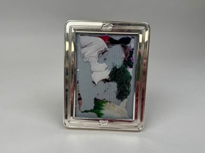 a silver picture frame with a picture of a woman on it