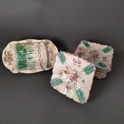 three pieces of porcelain dishes with floral designs on them on a gray surface