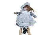 a doll that is wearing a white dress and a hat