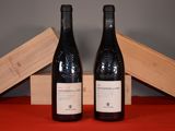 two bottles of wine sitting next to each other on a table